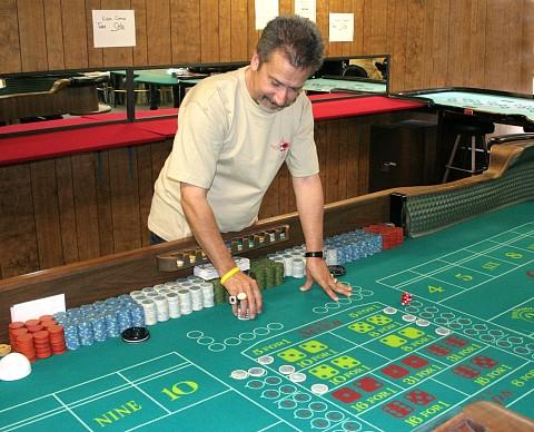 Nick Kallos sets up practice bets on the craps layout