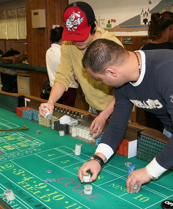 Students practice on the school's full size, regulation craps table