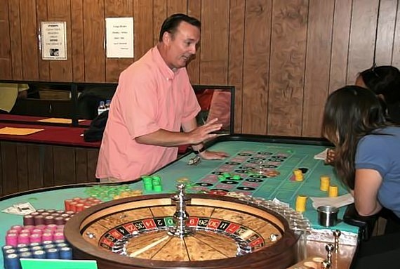 The instructor teaches students the procedures for dealing casino roulette