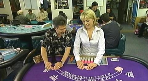 Monique gets a crash course in Blackjack dealing from Nick. 